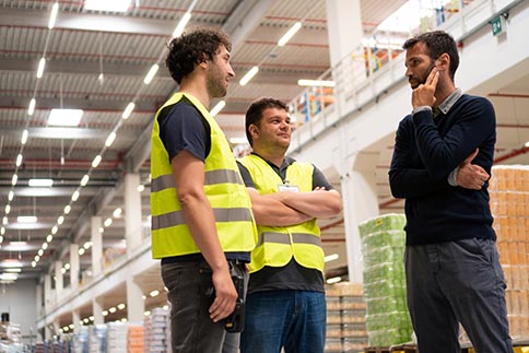 Safety consultant talking with 2 workers during safety inspection discovery visit